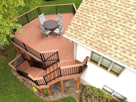 A Top view of a large multi-level deck attached to a two-story home.