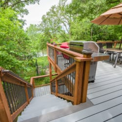 custom-decking-with-wooden-railing-and-stairs