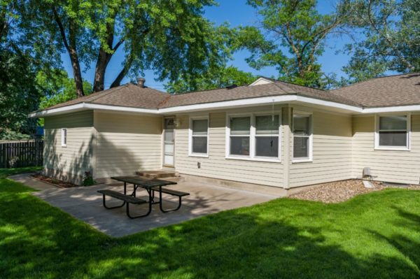tan, Ranch style home with patio and picnic table