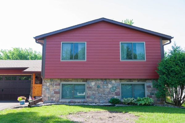 Home with new, red fiber cement siding