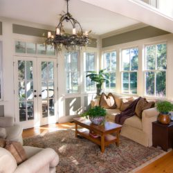 furnished sunroom with large windows and glass doors