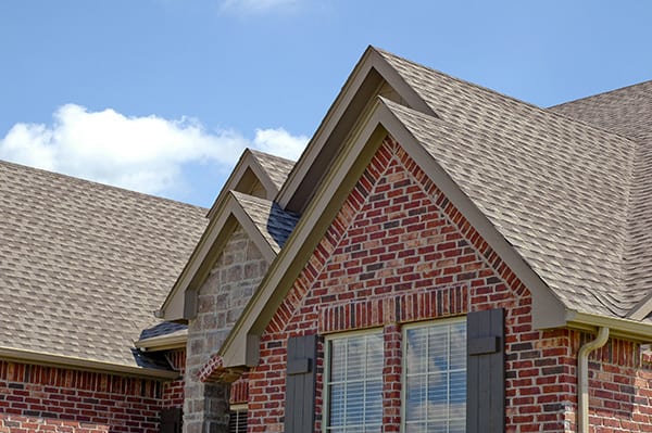 A brick home with a asphalt shingle roofing system. 